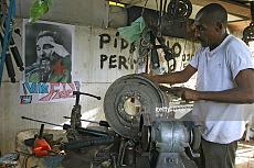 El mecanico-cuban-mechanic-repairs-car-tyre-his-workshop-decorated-picture-id78172358.jpeg